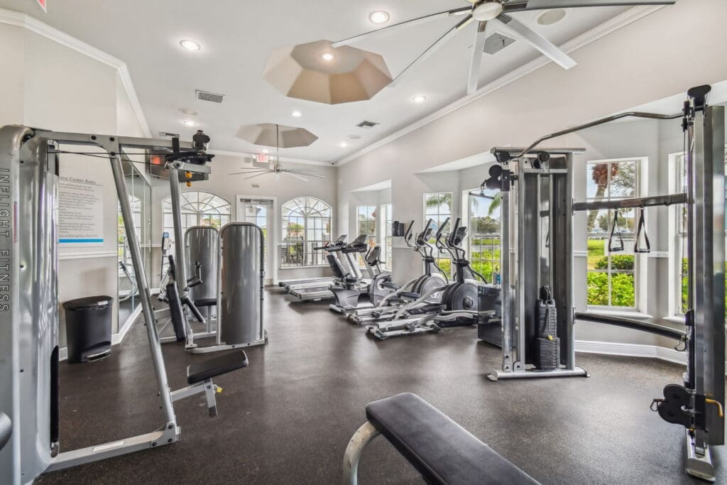 Three-Bedroom Apartments in Brandon, FL - 2211 Grand Isle - Spacious Fitness Center With Cardio Machines, Strength Equipment, Weight Bench, Large Windows, and Ceiling Fans.
